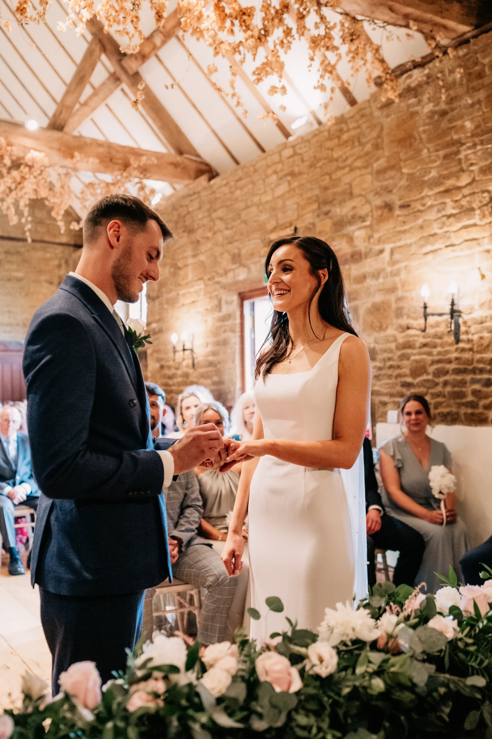 Groom Placing Ring On Bride